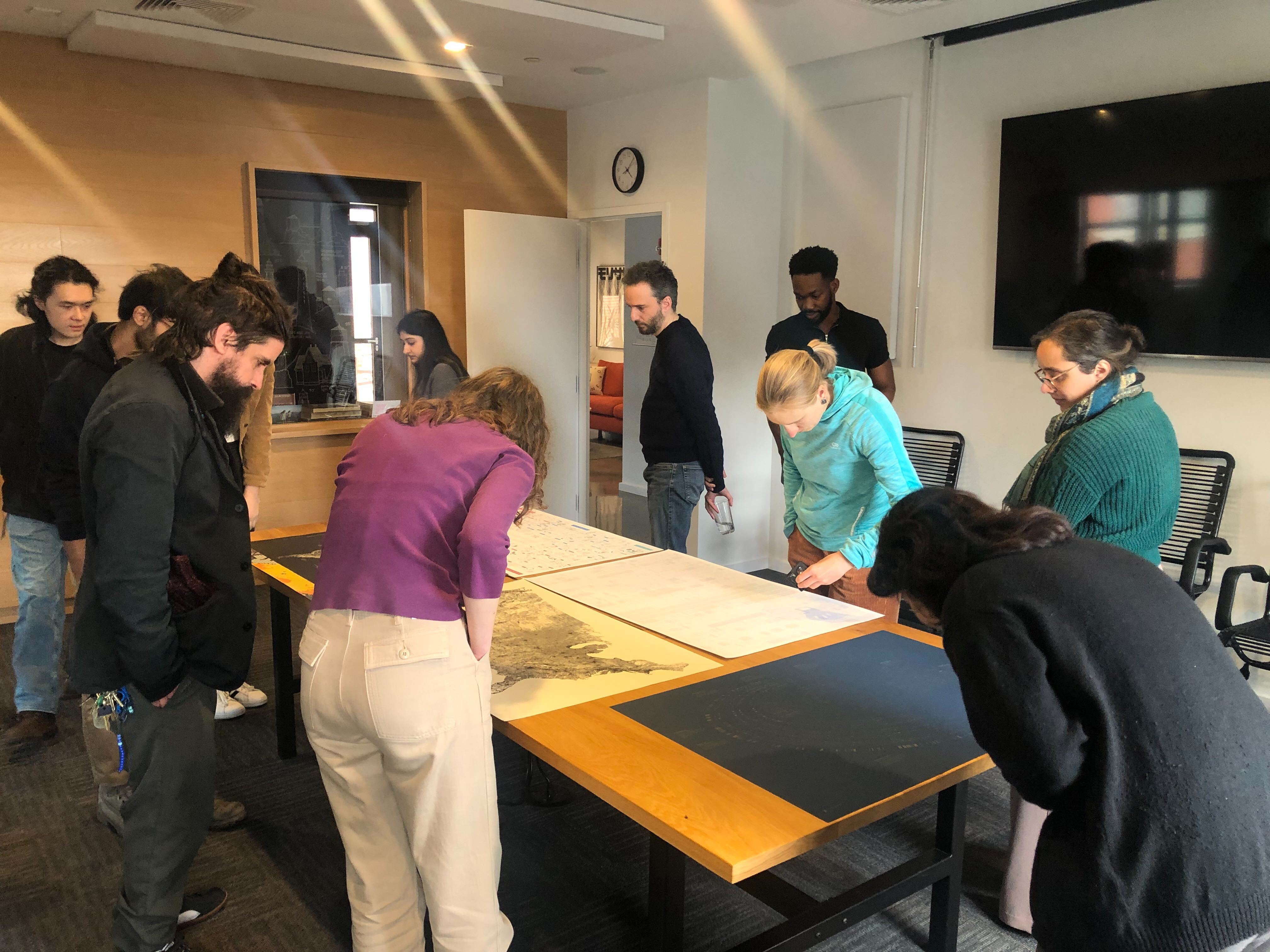 Members of the Broad’s Design Affinity Group gathered around a table full of our poster projects.